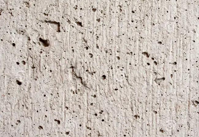 concrete surface with crack and spalls